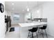Well-lit kitchen featuring a breakfast bar, white cabinetry, and stainless steel appliances at 11330 Burgundy Dr, Venice, FL 34293