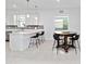 Bright, modern kitchen features white cabinets, quartz countertops, and stainless steel appliances at 11330 Burgundy Dr, Venice, FL 34293