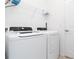 Clean laundry room featuring a modern washer and dryer, and white wire rack at 11330 Burgundy Dr, Venice, FL 34293