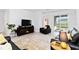 Well-lit living room with black leather furniture, a fireplace and a sliding glass door at 11330 Burgundy Dr, Venice, FL 34293