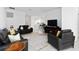 Cozy living room with black leather furniture, a modern fireplace, and an open-concept layout at 11330 Burgundy Dr, Venice, FL 34293