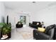 Spacious living room with neutral decor, comfortable seating, and access to outdoor patio at 11330 Burgundy Dr, Venice, FL 34293