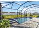 Inviting screened-in pool with hot tub, perfect for relaxing outdoors at 11330 Burgundy Dr, Venice, FL 34293