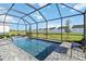 Sparkling screened-in pool and spa with patio offer beautiful backyard views of the neighborhood at 11330 Burgundy Dr, Venice, FL 34293
