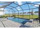 Beautiful screened-in pool with a hot tub and view of the backyard at 11330 Burgundy Dr, Venice, FL 34293