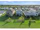 Aerial view showcasing the property's well-manicured lawn and landscaping among a community of homes at 6288 Winding Pine Dr, Nokomis, FL 34275