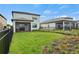 Spacious backyard offering a well-maintained lawn, modern fencing, and views of neighboring properties at 6288 Winding Pine Dr, Nokomis, FL 34275
