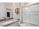 Well-lit bathroom featuring a shower over tub, white subway tile, and modern fixtures at 6288 Winding Pine Dr, Nokomis, FL 34275