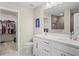 Elegant bathroom featuring a double vanity, a water closet, and a spacious walk-in closet at 6288 Winding Pine Dr, Nokomis, FL 34275