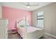 Adorable pink bedroom featuring a whimsical bed frame, a pink accent wall, and a cozy atmosphere at 6288 Winding Pine Dr, Nokomis, FL 34275
