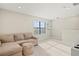 Bright bonus room with neutral decor, carpet, and a comfortable couch, perfect for relaxation at 6288 Winding Pine Dr, Nokomis, FL 34275