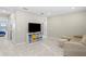 Upstairs bonus room with neutral carpet, comfortable seating, and a TV for entertainment at 6288 Winding Pine Dr, Nokomis, FL 34275