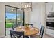 Cozy breakfast nook features a wooden table set for four with an outdoor view of the screened-in patio at 6288 Winding Pine Dr, Nokomis, FL 34275