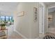 Bright hallway with wood-look tile flooring, leading to the living area and other rooms at 6288 Winding Pine Dr, Nokomis, FL 34275