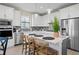 Contemporary kitchen featuring a white island with seating and stainless steel appliances at 6288 Winding Pine Dr, Nokomis, FL 34275
