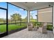 Enjoy the outdoors in this screened lanai with comfortable seating and scenic views of the surrounding landscape at 6288 Winding Pine Dr, Nokomis, FL 34275