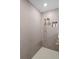 Modern tiled shower featuring a rainfall showerhead, a handheld showerhead, and a recessed niche for toiletries at 6288 Winding Pine Dr, Nokomis, FL 34275