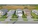 Street view of homes featuring manicured lawns, paved driveways, and landscaping at 6288 Winding Pine Dr, Nokomis, FL 34275
