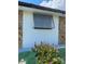 Exterior side view of the house with a window and a flower bush at 12322 Alta Mira St, North Port, FL 34287