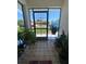 Inviting front porch featuring decorative tile flooring and plants, creating a warm entrance to the home at 12322 Alta Mira St, North Port, FL 34287