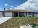 Charming one-story home with a well-maintained lawn and a stone-accented facade at 12322 Alta Mira St, North Port, FL 34287