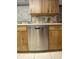 Kitchen featuring wood cabinets, laminate countertops, stainless steel dishwasher at 12322 Alta Mira St, North Port, FL 34287