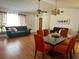 Bright living and dining area with hardwood floors, modern lighting, and comfortable seating at 12322 Alta Mira St, North Port, FL 34287