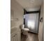 Updated bathroom featuring black tiling around shower and vinyl flooring at 147 Melanie Ln, Brandon, FL 33510