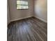 A bright bedroom featuring vinyl flooring and large window at 147 Melanie Ln, Brandon, FL 33510
