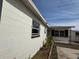 Side view of home displaying painted concrete brick and dark trim windows at 147 Melanie Ln, Brandon, FL 33510