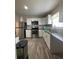 Modern kitchen featuring stainless steel appliances, granite countertops, and white cabinets at 147 Melanie Ln, Brandon, FL 33510