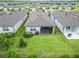 Aerial view of backyard featuring a well maintained lawn, landscaping and a screened-in patio with furniture at 19165 Iron Topsail Isle, Land O Lakes, FL 34638