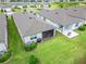 Aerial view of backyard featuring a well maintained lawn, landscaping, a screened-in patio, and outdoor kitchen at 19165 Iron Topsail Isle, Land O Lakes, FL 34638