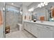 Elegant bathroom showcasing double vanities, a glass-enclosed shower, and contemporary design elements at 19165 Iron Topsail Isle, Land O Lakes, FL 34638