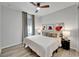 Cozy bedroom with modern ceiling fan, stylish curtains, and striking abstract wall art at 19165 Iron Topsail Isle, Land O Lakes, FL 34638