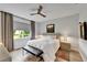 Serene bedroom features wood-look floors, neutral tones, a ceiling fan, and a peaceful ambiance at 19165 Iron Topsail Isle, Land O Lakes, FL 34638