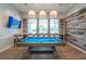Billiard room features a blue billiard table, chairs and mounted TV for entertainment and relaxation at 19165 Iron Topsail Isle, Land O Lakes, FL 34638