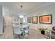 Open floor plan featuring dining area with modern light fixture and a view to the kitchen at 19165 Iron Topsail Isle, Land O Lakes, FL 34638