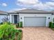 Beautiful one-story home with brick driveway, well-maintained landscaping, and modern curb appeal at 19165 Iron Topsail Isle, Land O Lakes, FL 34638