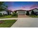 Charming single-story home with a brick driveway, manicured landscaping, and a well-kept lawn at 19165 Iron Topsail Isle, Land O Lakes, FL 34638