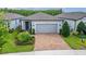 Charming single-story home featuring a brick driveway, well-manicured landscaping, and a neutral color palette at 19165 Iron Topsail Isle, Land O Lakes, FL 34638