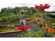Scenic community garden with vibrant flowers, plants, and a charming pavilion, perfect for nature lovers at 19165 Iron Topsail Isle, Land O Lakes, FL 34638
