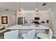 Modern kitchen featuring white cabinets, stainless steel appliances, and a spacious island with seating at 19165 Iron Topsail Isle, Land O Lakes, FL 34638