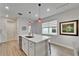 Kitchen island features modern sink and faucet, and bar seating with nearby window for natural light at 19165 Iron Topsail Isle, Land O Lakes, FL 34638