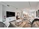 Open-concept living room boasts modern lighting, stylish furnishings, and seamless flow to kitchen and dining area at 19165 Iron Topsail Isle, Land O Lakes, FL 34638