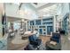 Bright and stylish lounge area features hardwood floors, sofa, comfy chairs and elegant shelving at 19165 Iron Topsail Isle, Land O Lakes, FL 34638