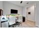 Contemporary home office with dual monitors, stylish white chairs, and ample desk space at 19165 Iron Topsail Isle, Land O Lakes, FL 34638