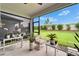 Comfortable outdoor seating on screened-in patio with a lovely garden view at 19165 Iron Topsail Isle, Land O Lakes, FL 34638