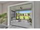 Relaxing covered patio with fan, seating, and a view of the manicured lawn at 19165 Iron Topsail Isle, Land O Lakes, FL 34638