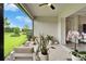 Inviting screened-in patio with seating, lush plants, and serene outdoor views at 19165 Iron Topsail Isle, Land O Lakes, FL 34638